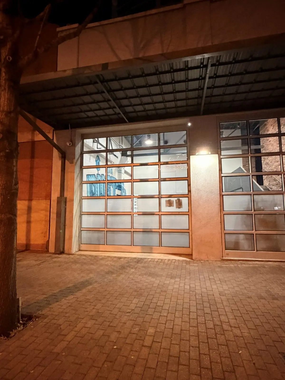Full view glass overhead doors in a brick commercial space