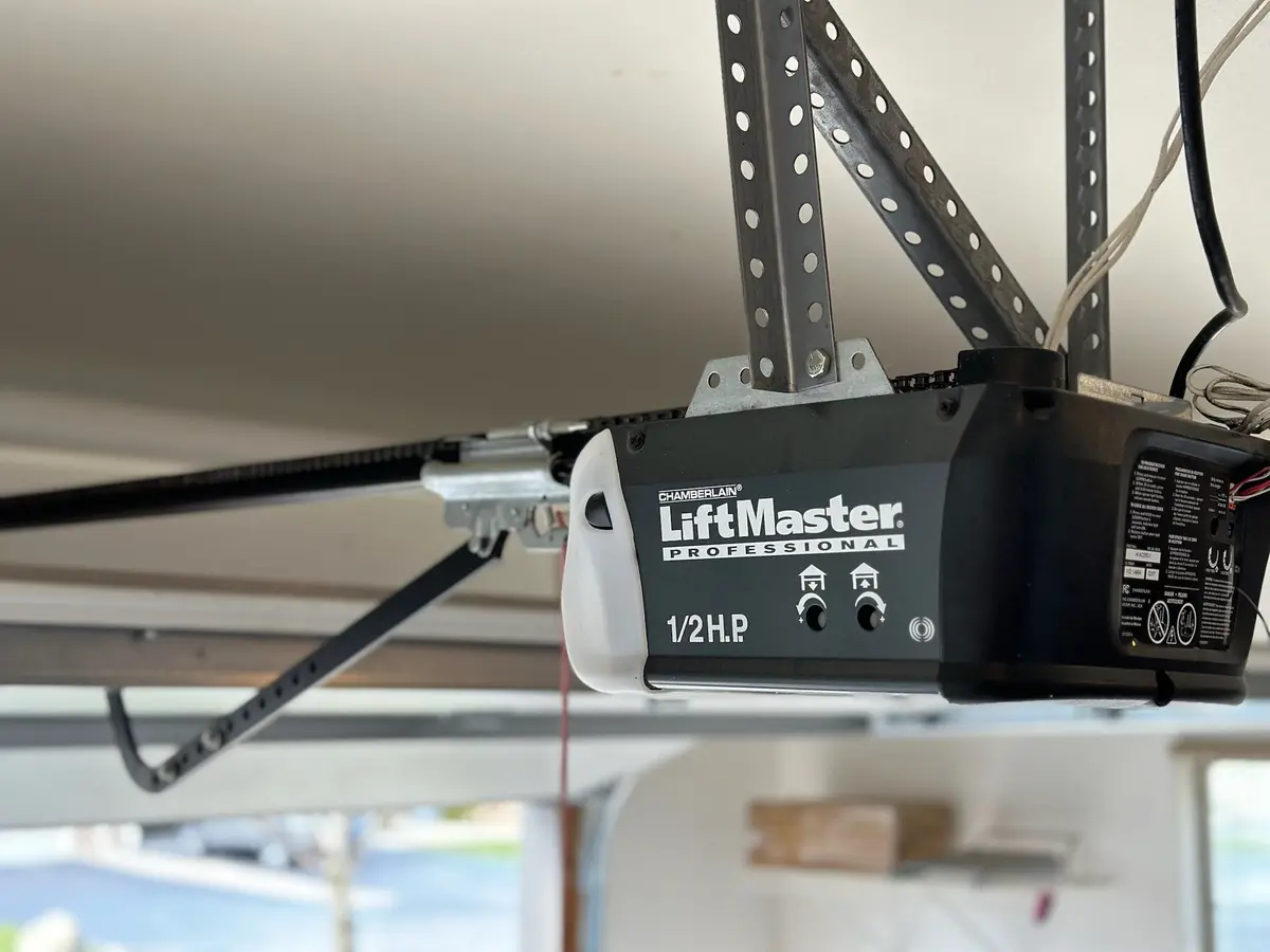 LiftMaster garage door opener and rail mounted on a garage ceiling