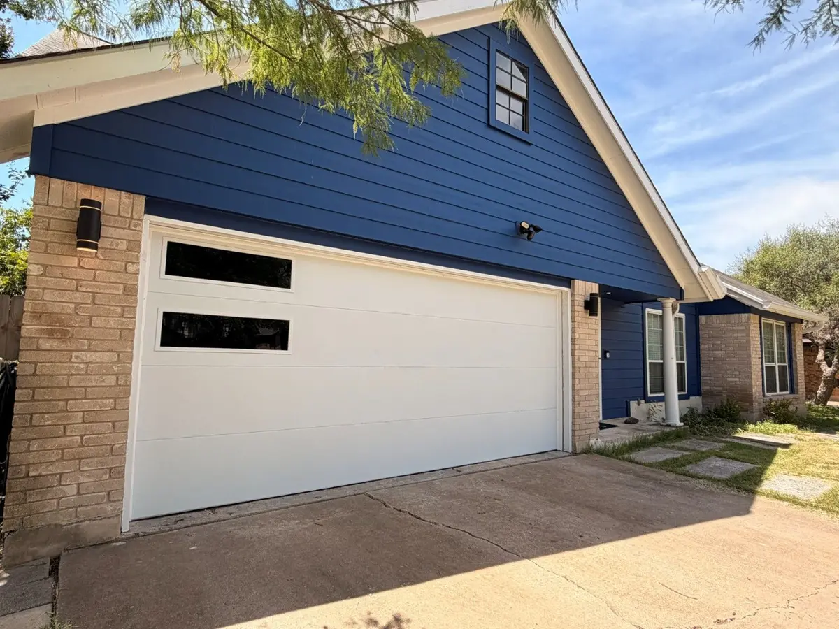 White flush garage door with black side windows, installed by Tier One