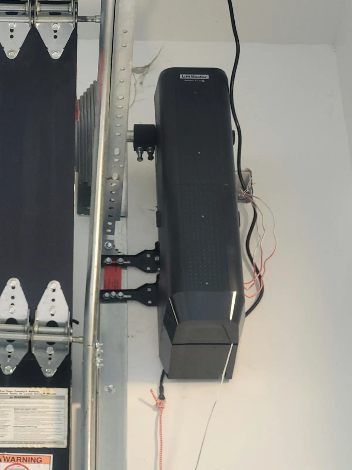 LiftMaster wall mount garage door opener installed beside the door on the torsion shaft